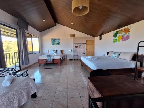 a large room with two beds and a couch at Monteverde Cecropia Paradise in Monteverde Costa Rica
