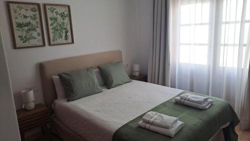 a bedroom with a bed with two towels on it at Iris 25 in Playa Blanca