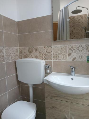 a bathroom with a white toilet and a sink at Nel cuore di Segesta in Calatafimi