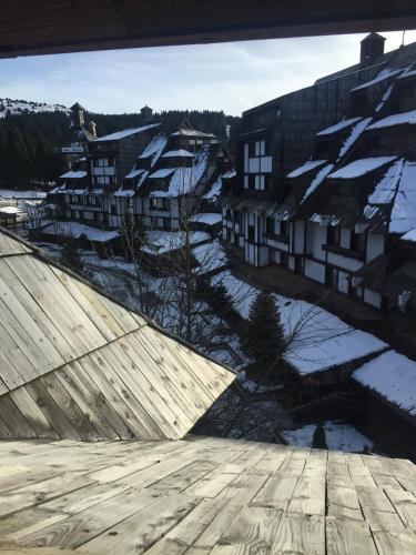 a view of a city with snow covered buildings at Apartments Suncani Vrhovi Kopaonik in Kopaonik