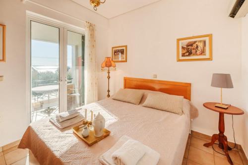 a bedroom with a large bed and a window at Golden Tiara Apartment in Barbati
