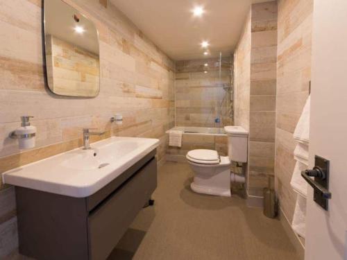 a bathroom with a sink and a toilet and a mirror at Franks- 2nd Floor Apt-2 Bath-Cowes Centre-Sleeps 4 in Cowes