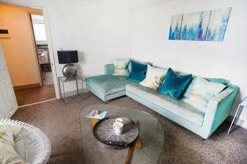 a living room with a couch and a table at Franks- 2nd Floor Apt-2 Bath-Cowes Centre-Sleeps 4 in Cowes