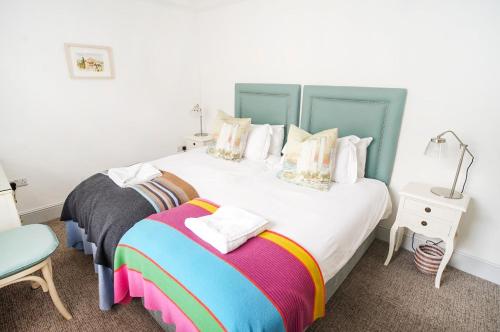 a bedroom with two beds and a table and a lamp at Paskins - Cowes in Cowes
