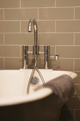 a bathroom with a sink with a faucet at Paskins - Cowes in Cowes