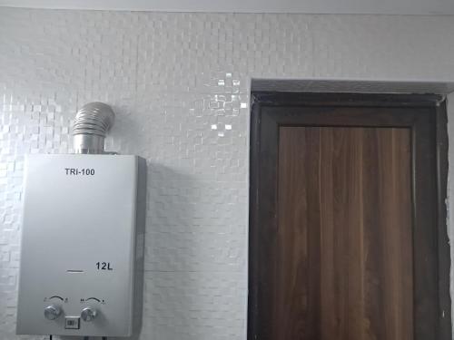 a light next to a door in a room at Hotel kazbegi1 in Ach'khoti
