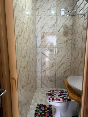 a bathroom with a shower with a toilet and a sink at Chácara Desejo do Coração 1 in Juquitiba