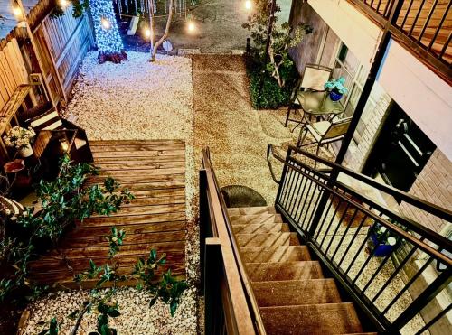 an overhead view of a staircase in a building with plants at Spotless Full Sized Apartment! Montrose Stays An Art Lover's Dream in Houston