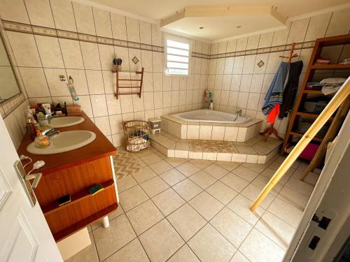 an overhead view of a bathroom with a tub and sink at Villa Annaga in Saint-Paul