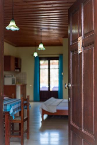 a room with a room with a bed and a door at Iliopetra in Douliana