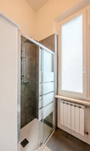 a bathroom with a shower and a window at Casa Altini in San Miniato