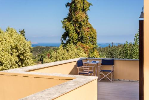 a view from the balcony of a house with a table and chairs at Iliopetra in Douliana