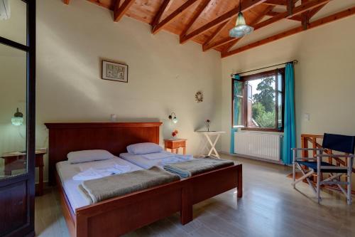 a bedroom with a large bed in a room at Iliopetra in Douliana