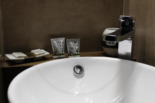 a bathroom with a white sink and a coffee maker at La Cupola Suite in Rome