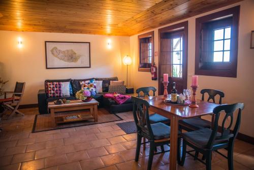 a living room with a table and a couch at Villa Ricardo in Porto da Cruz