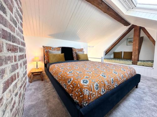 a bedroom with a king sized bed in a attic at Villa Ancestor - Etretat in Étretat