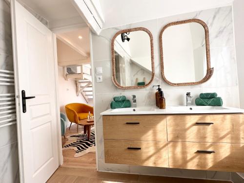 a bathroom with a sink and two mirrors at Villa Ancestor - Etretat in Étretat