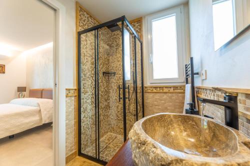 a bathroom with a large tub and a bedroom at Elisir Di Pace in Nardò