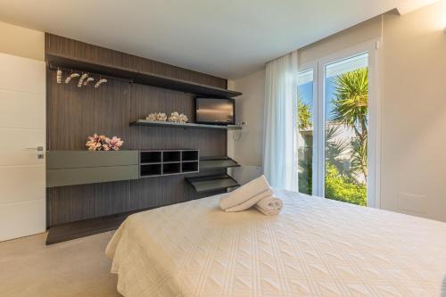 a bedroom with a large bed and a window at Elisir Di Pace in Nardò