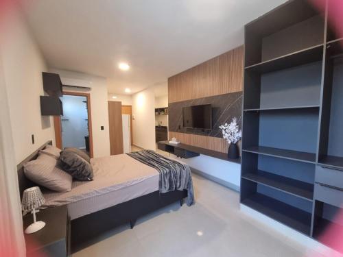 a bedroom with a bed and a television in a room at Studio Proximo Anashopping Kitnet 101 in Anápolis