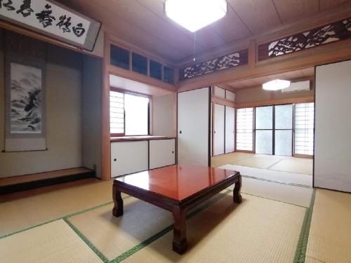 a room with a table and some windows at Satoyama no Yado Kei-House - Vacation STAY 55796v in Shikokuchuo