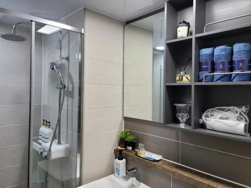 a bathroom with a shower and a sink at 오늘도광안씨 in Busan