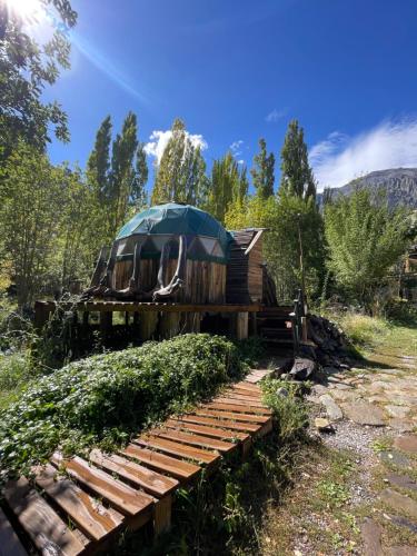 a house sitting on top of a wooden bridge at Hostal Crisol in Refugio Lo Valdés