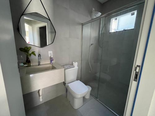 a bathroom with a shower and a toilet and a sink at Residenc Mazonetto in Primavera do Leste