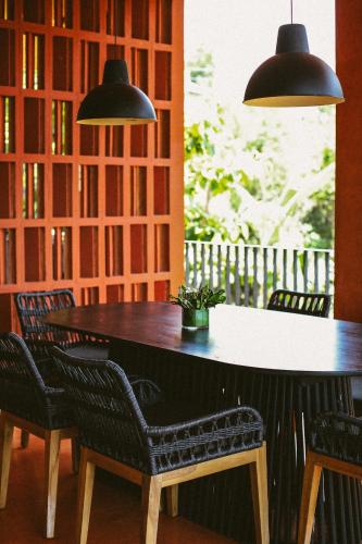 a table and chairs in a room with books at C South Hideout in Butong