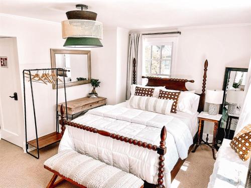 a bedroom with a bed and a chair in it at Buttonwood Hotel 1 - Boutique Accommodations in Cape May
