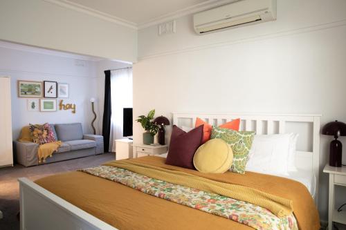 a bedroom with a large bed and a couch at Clara Luce` in Bright