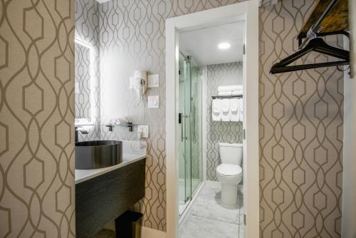 a bathroom with a sink and a toilet at The Vic, an Ascend Collection Hotel in Victoria