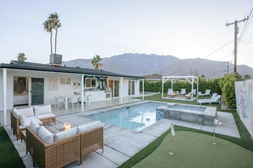 a backyard with a pool and a house at Palm Vista by Rather Be Properties in Palm Springs