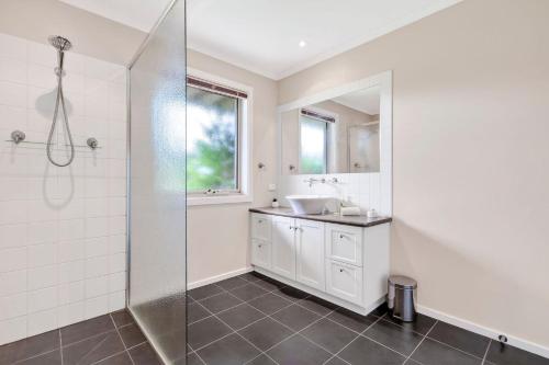a bathroom with a sink and a shower at The Dunes 1 - BYO Linen in Apollo Bay