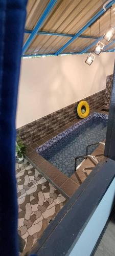 a swimming pool with a yellow object in a room at Marang Private Pool Homestay - 3-Bedroom - Family & Group Stay in Marang