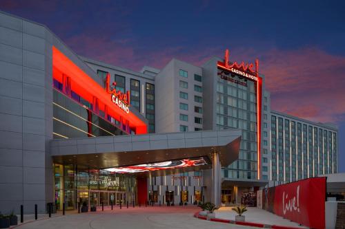 a large building with red lights on it at Live Casino & Hotel Louisiana, Curio Collection by Hilton in Bossier City