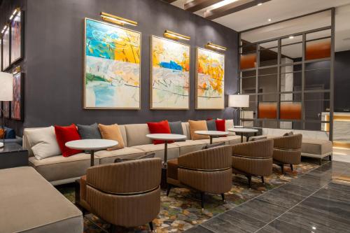 a lobby with a couch and tables and chairs at Live Casino & Hotel Louisiana, Curio Collection by Hilton in Bossier City