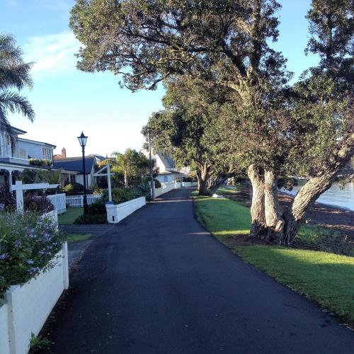 a long road with trees and houses on it at Seaport Village in Russell