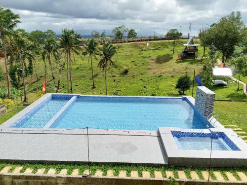 an overhead view of a swimming pool in a field at Mccp glamping and resort in Cavinti