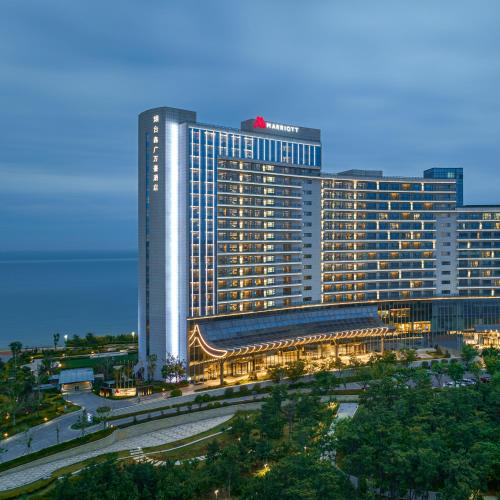 a large building in a city at night at Yantai Marriott Hotel in Yantai