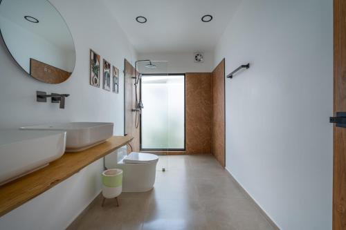a bathroom with a sink and a mirror at Sea Escapes Villas in Thong Sala