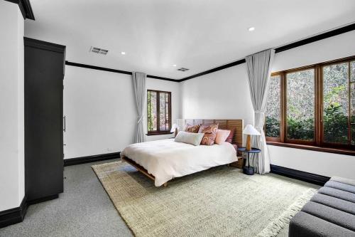 a bedroom with a bed and some windows at Villa Donini in Riverside