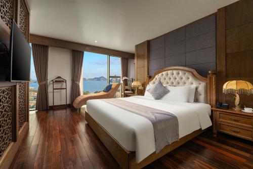 a bedroom with a large bed and a large window at Cat Ba Paradise Hotel - Sky Bar & Massage in Cat Ba