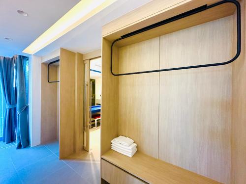 a room with a large wooden wall with a door at The Yama Hotel Phuket in Kata Beach