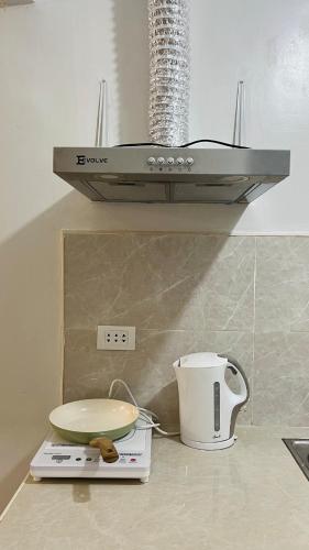 a kitchen counter with a sink and a toaster at Solara Villa, Gensan in General Santos