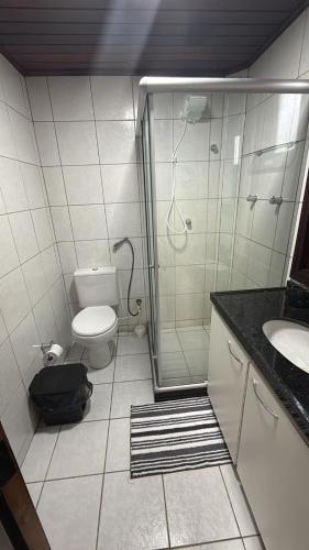 a bathroom with a shower and a toilet and a sink at Privê Refúgio Gravatá in Gravatá