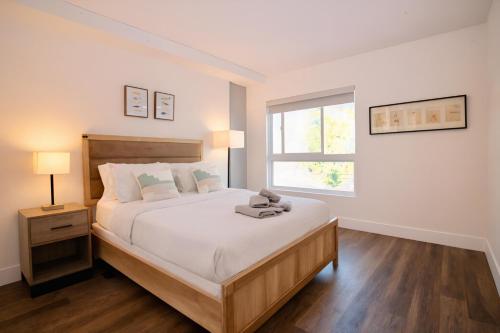 a bedroom with a large bed and a window at Los Angeles Premium City Suites - Free Secured Parking in Los Angeles