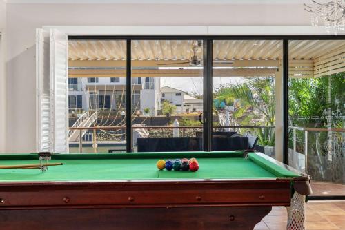 a pool table in a living room next to a patio at Spacious 4BR Waterfront Stay Pool Table AC in Newport