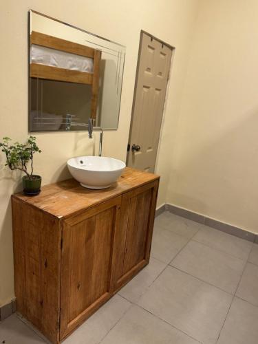 a bathroom with a sink and a mirror at Islas Boho Tiny Home - Main strip El Tunco in El Sunzal