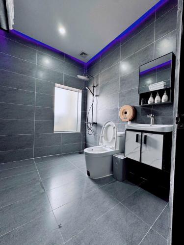 a bathroom with a toilet and a sink at Khách sạn Thy Thảo 3 in Ho Chi Minh City